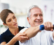 Therapist helping a man with recovery exercises